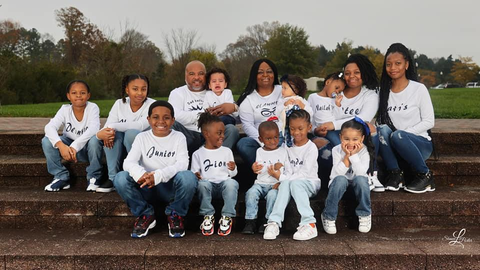 Dr. Zandra Sims and her family gathered together on outdoor steps